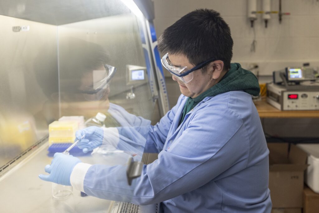 Zhenyu Ma, research fellow in civil and environmental engineering, places chemical droplets in a test tube at professor of civil and environmental engineering Herek Clack’s lab at the G.G. Brown Laboratory on North Campus at the University of Michigan. Image credit: Gabi Iriarte/Michigan Engineering, Communications & Marketing