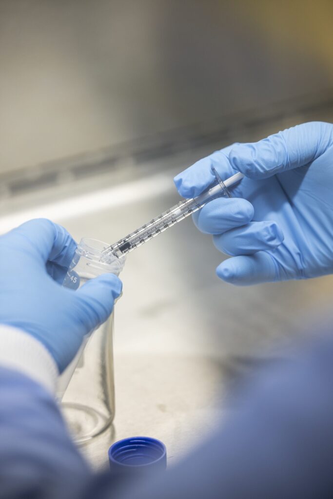 Placing chemical droplets in a test tube at professor of civil and environmental engineering Herek Clack’s lab at the G.G. Brown Laboratory on North Campus at the University of Michigan. Image credit: Gabi Iriarte/Michigan Engineering, Communications & Marketing