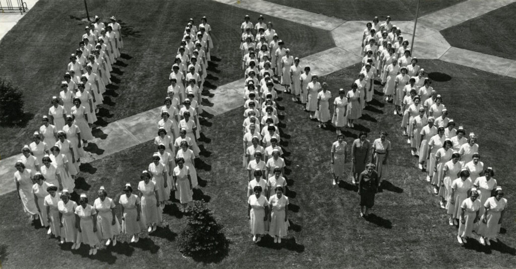 Nursing students from the Class of 1960 stand in "U-M" formation on the Diag