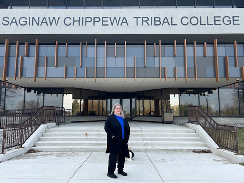 Jennifer Daniels posing in front of Saginaw Chippewa Tribal College