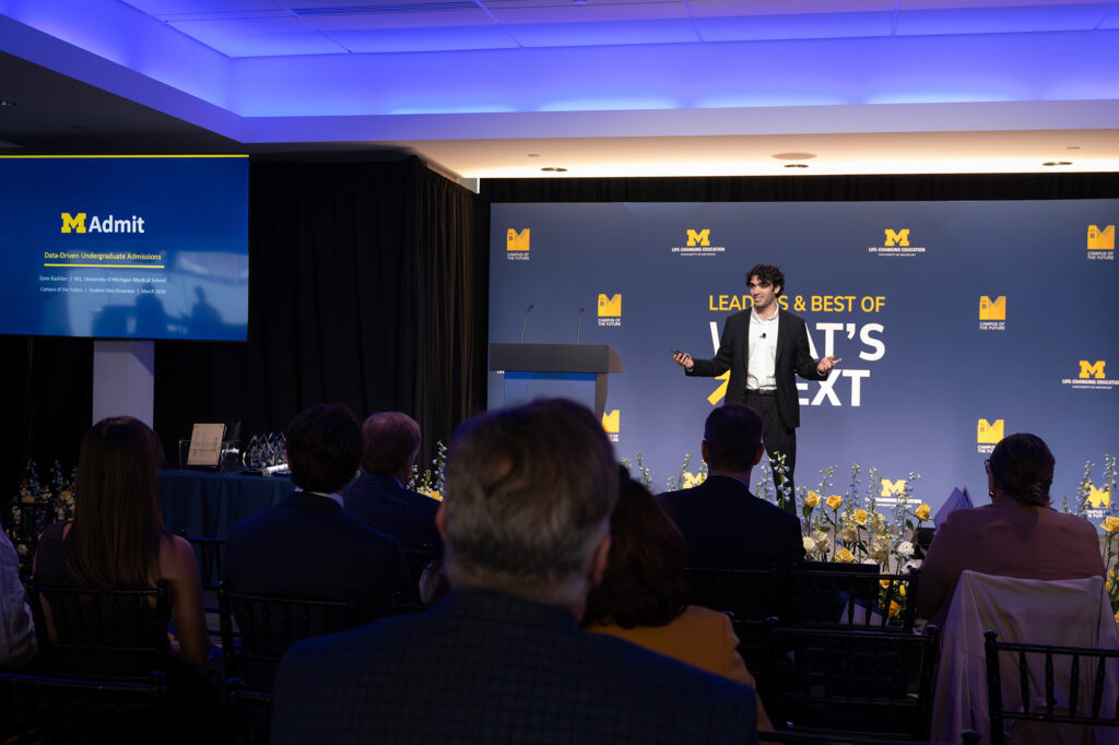 A person stands in front of a group and delivers a presentation