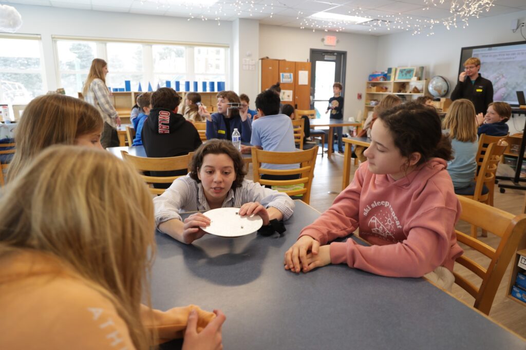 U-M student Abby Ayala teaches Daycroft School students about microplastics. Image credit: Jeremy Marble, University of Michigan News