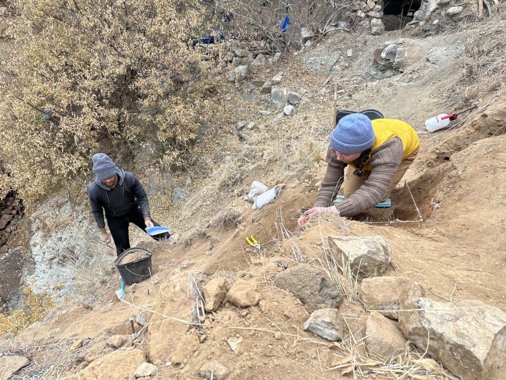 Researchers Lefa Leanya of Stellenbosch University, South Africa, and Kyra Pazan of California State University, Stanislaus, excavate Likonong Rock Shelter in the mountains of Lesotho. Here, an international team of archaeologists from the United States, Canada, the United Kingdom, and Lesotho have identified the earliest sustained human occupation in Highland Southern Africa. Image credit: Kyra Pazan, California State University, Stanislaus